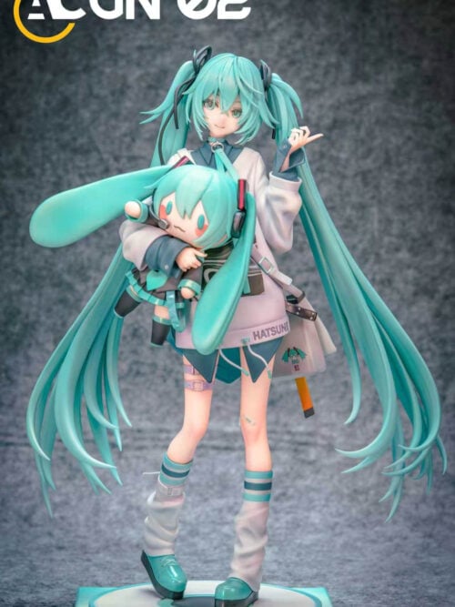 Front view of Hatsune Miku holding a Miku doll, with long turquoise twin-tails, a pale oversized top and platform shoes.