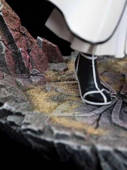 Close-up of Inoue Orihime's black boots with white trim on a cracked stone-style base surrounded by jagged rocks.
