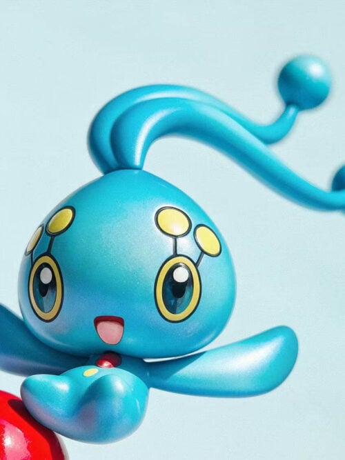 Close-up of Manaphy with long antennae sweeping to the right, an open-mouthed smile and outstretched flipper-like arms.