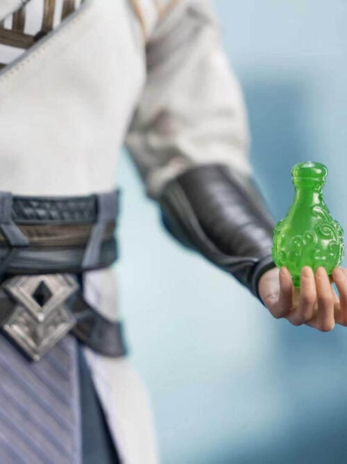 Close-up of Han Li's hand holding the translucent green Zhangtian Bottle beside his dark belt and armored forearm.