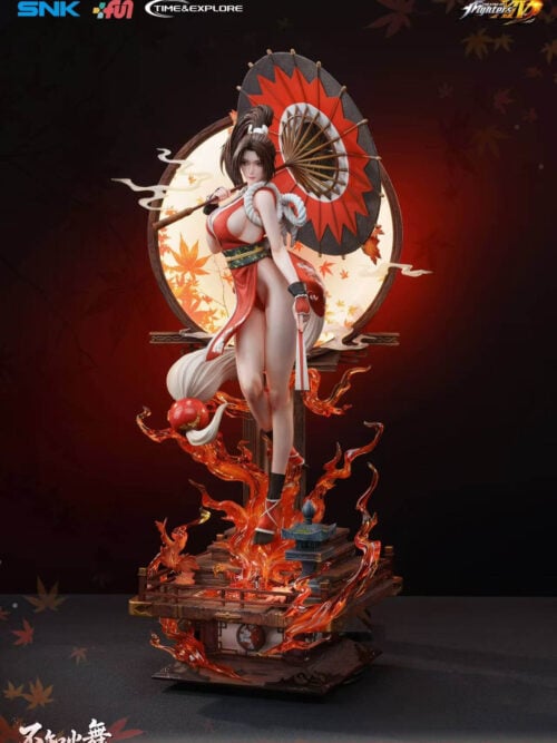 Mai Shiranui holding a red-and-black parasol and closed fan before a circular maple-leaf screen, above a flame-covered platform base.