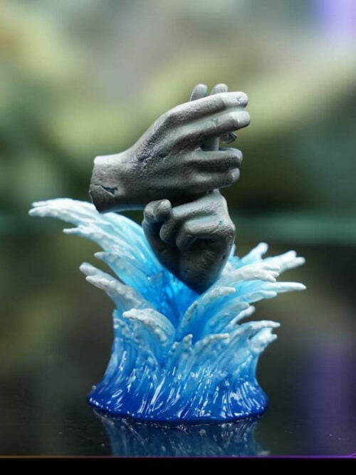 Seal of Reconciliation bonus sculpture with two gray hands forming a joined gesture above a blue-and-white water-effect base.