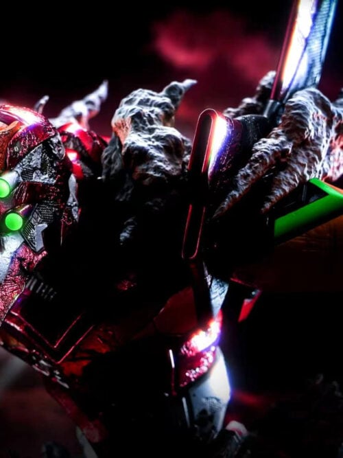 Low-light close-up of Unit-02's four glowing green eyes beneath its orange forehead armor.