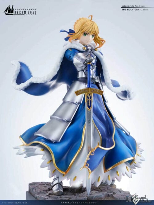 Vertical three-quarter view of Altria Pendragon showing her white-trimmed blue cloak, gold-edged skirt, silver armor and downward-pointing sword.