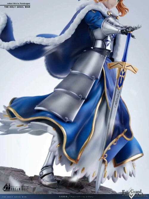 Angled detail of Altria Pendragon's armored hand on the sword pommel, layered hip armor, flared blue skirt and sword tip at the stonework.
