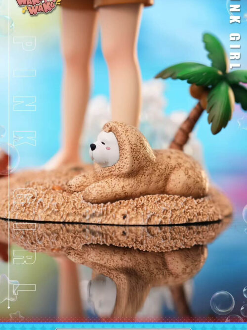 Close-up of sand-covered Bond on the textured beach base, with Anya's bare feet, a small palm tree and a wave behind him.