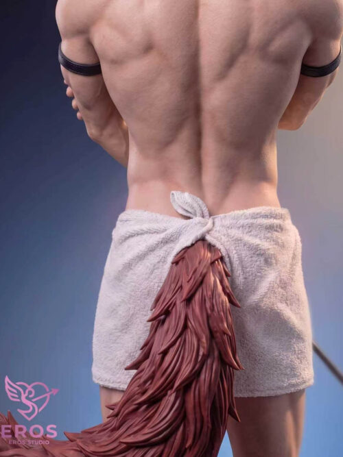 Rear close-up of Valko showing his back, upper-arm bands and a white towel tied above the reddish tail.