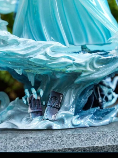 Natural-light close-up of Rukia's layered ice-effect base with curling translucent forms, icicles and dark sculpted details beneath the robe hem.