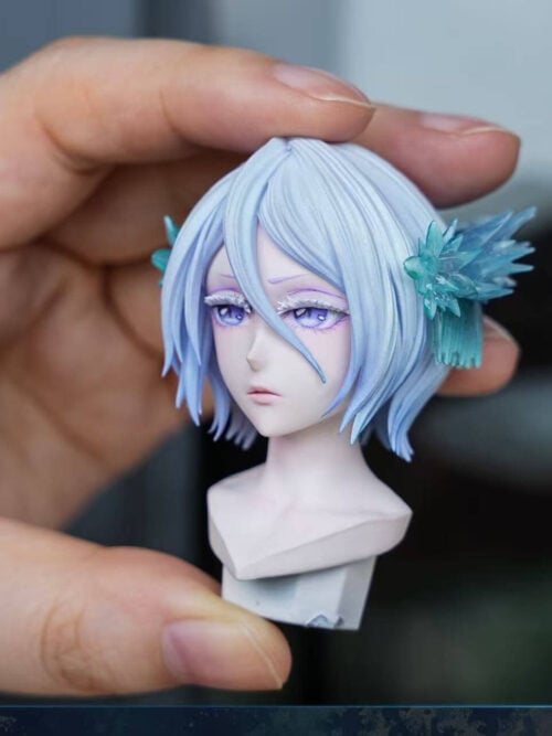Three-quarter handheld view of Rukia's Beautiful Head sculpt, showing violet eyes, layered pale hair and a blue crystalline side ornament.