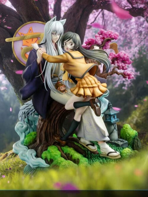 Tomoe and Nanami on their tree-centered scenic base, displayed against a pink-blossom woodland backdrop with drifting petals.