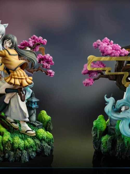 Front and rear views of the Tomoe and Nanami diorama, showing the blossom tree, circular ornament, pale-blue effects and rocky base.