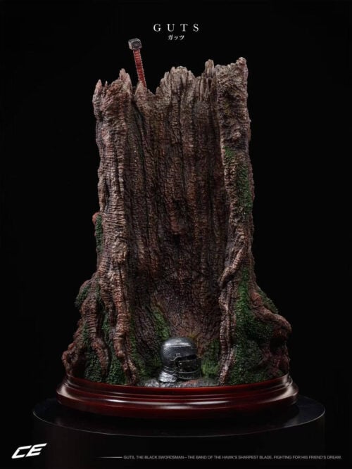 Rear view of the Guts statue showing the broken tree trunk, moss-covered roots, a helmet at the base and the sword hilt above.