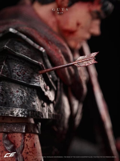 Close-up of an arrow embedded in Guts's layered shoulder armor, with his face and sword blurred behind it.