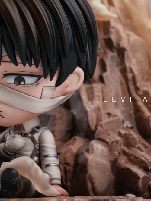 Wide close-up of chibi Levi Ackerman seated against rocks, showing his bandaged face, raised fist and smoke across one boot.