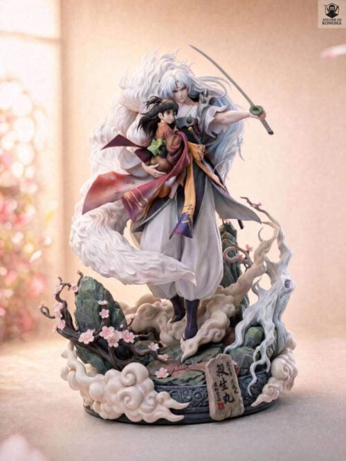 Three-quarter view of Sesshomaru holding Rin with a drawn sword, sweeping white fur and a complete cloud-and-rock base with pink blossoms.