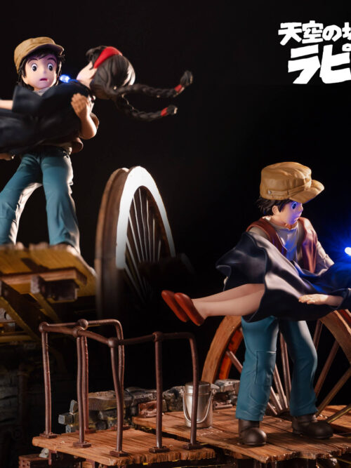 Two angled views of Pazu carrying Sheeta on a plank platform, with railings, a small bucket and a large spoked wheel.