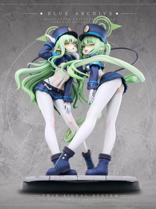 Low-angle view of Hikari and Nozomi figures with sweeping green hair and blue hats, standing together on a circular base.