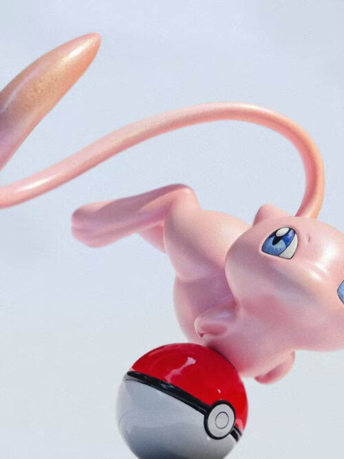 Low-angle close-up of pink Mew with blue eyes, tucked limbs and a long curved tail above a red-and-white Poké Ball.
