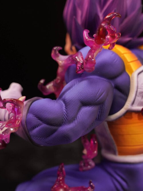Rear three-quarter close-up of Vegeta's textured purple shoulder and arm, with pink aura effects beside the back armor.