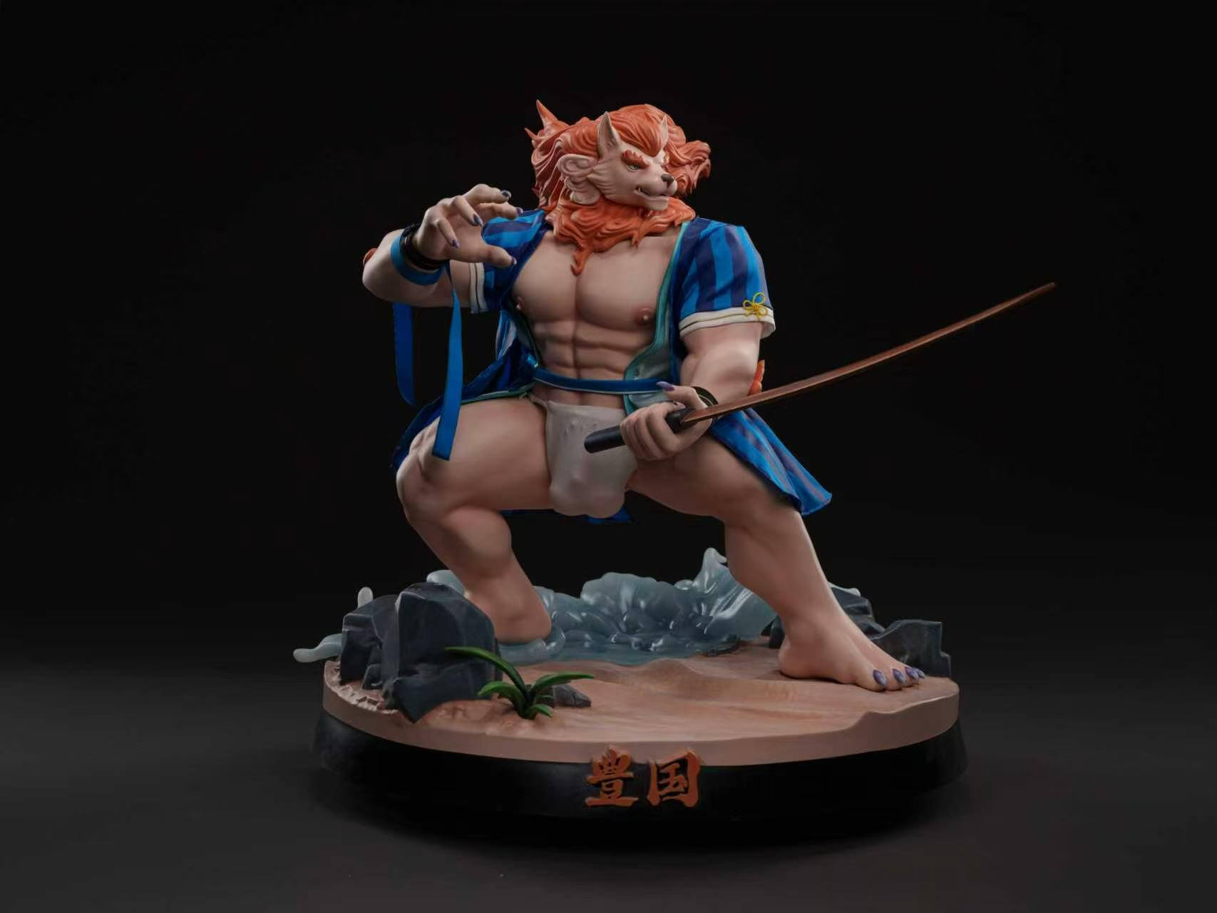 Toyokuni Summer Festival - Front Full View Toyokuni statue in a blue-striped haori and white loincloth, holding a sword above a sandy base with rocks and waves.