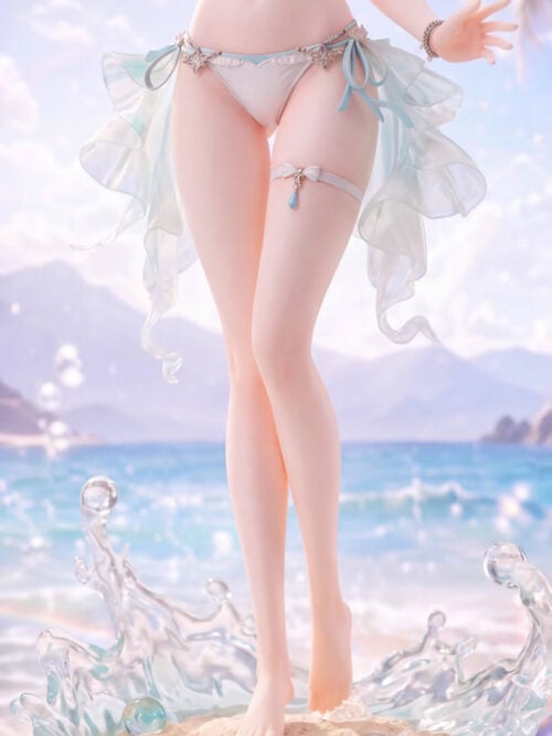 Detail of Firefly's translucent aqua side drapes, lifted bare foot and sand-textured base surrounded by pale-blue waves.