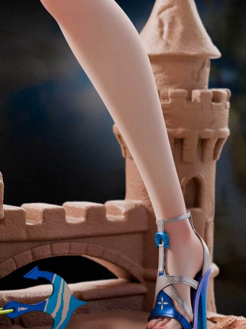 Silver-and-blue platform heel on a sandcastle base with a tower, arched bridge, shell and starfish.