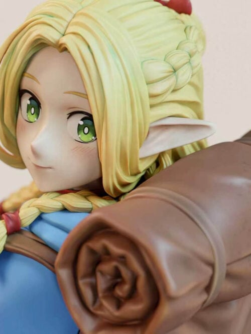 Marcille Donato close-up with green eyes, blonde braids and one hand holding a backpack strap beside a rolled bedroll.