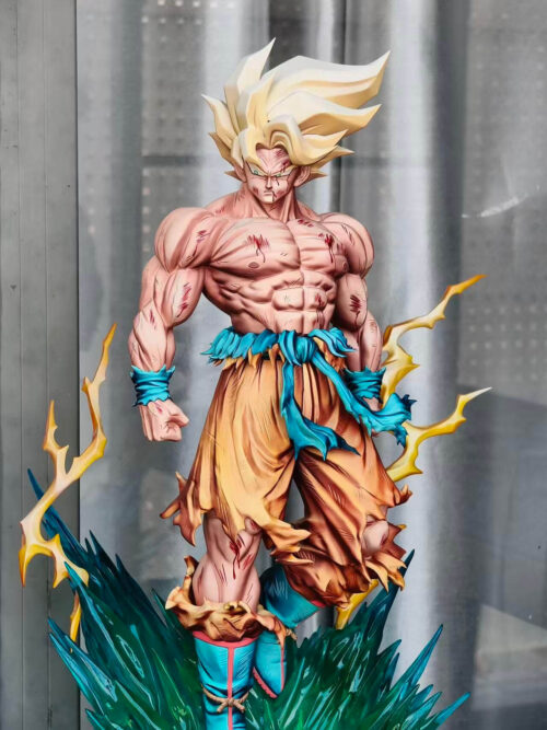 Close front view of Super Saiyan Son Goku showing a stern expression, battle-marked torso, clenched fists and a trailing blue sash.