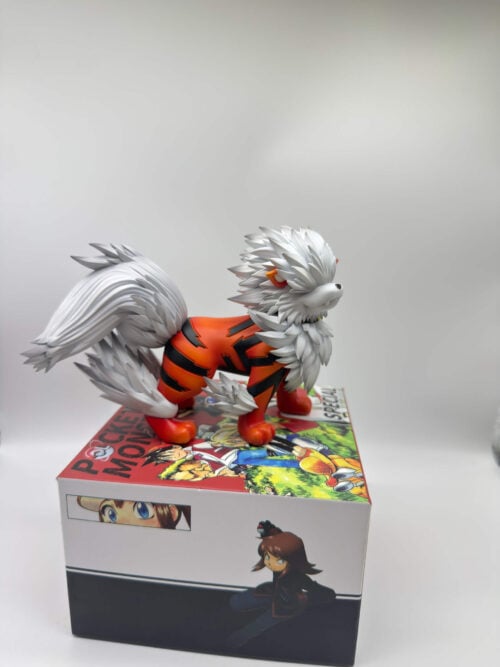 Side three-quarter view of Arcanine on an illustrated box, showing orange-and-black stripes, a layered white mane and a sweeping raised tail.