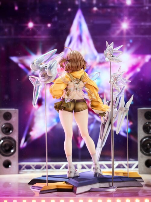 Full rear view of Anis with translucent wing-like ornaments, a yellow hood and olive shorts above a purple-and-yellow star base.