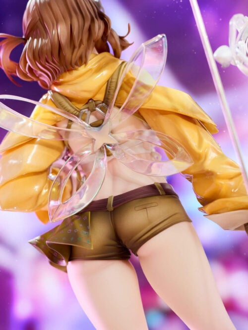 Rear close-up of Anis showing translucent wing-like loops around a silver star, shoulder straps and the folds of her yellow jacket.
