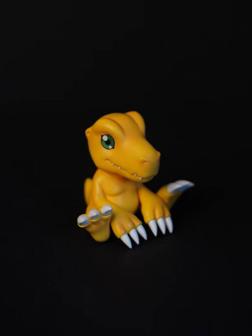 Three-quarter view of seated Agumon facing right, with a green eye, small teeth and white claws against black.