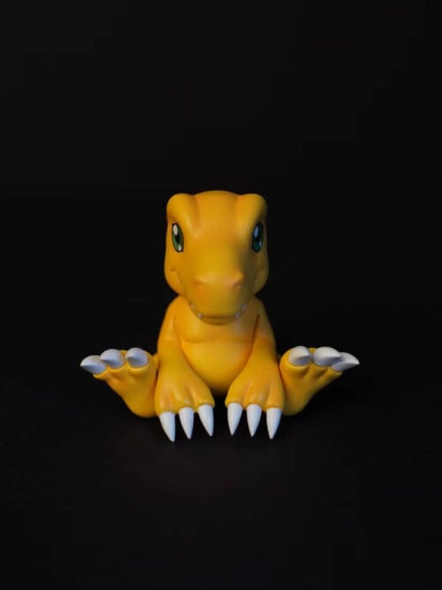 Front view of C9 Studio's seated Agumon with green eyes, outward-spread feet and long white hand claws against black.