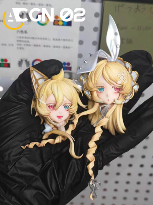 Two detached Kagamine Rin and Len head sculpts held in a black-gloved hand, showing rabbit and cat ears and pink-and-blue eyes.