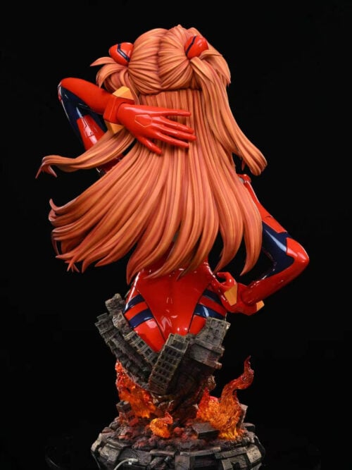Rear view of Asuka's bust showing long orange hair, a red-gloved hand behind her head and the ruined-city flame base.