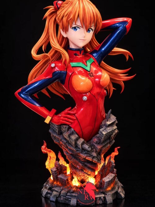 Full front view of Asuka's red-plugsuit bust with flowing orange hair, illuminated flame effects and a ruined-city base with a NERV emblem.