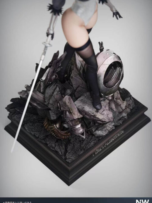 Angled close-up of 2B's base with cracked rubble, exposed gears and a hollow machine shell beneath her boots and sword.