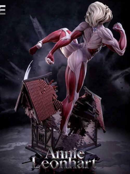 Rear view of the Female Titan statue showing pale layered hair, back musculature and broken timber-framed buildings.