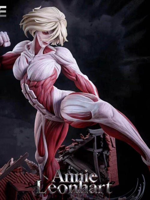 Close-up of the Female Titan's pale hair, face, raised fist and red-and-ivory musculature, with ruined rooftops below.