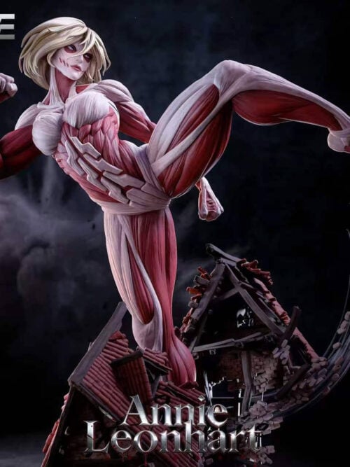 Front detail of the Female Titan statue showing her face, clenched fist and raised leg above damaged roofs and sweeping rubble.