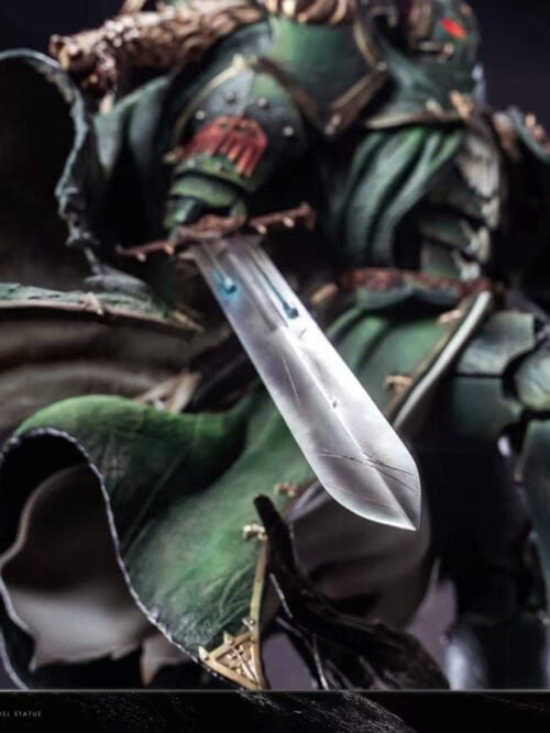 Close-up of Lion El'Jonson's lowered sword blade against the torn green cloak, with armor and shield behind it.
