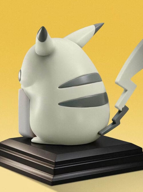 Rear three-quarter view of monochrome Pikachu with gray back stripes and a raised lightning-shaped tail on a black base.