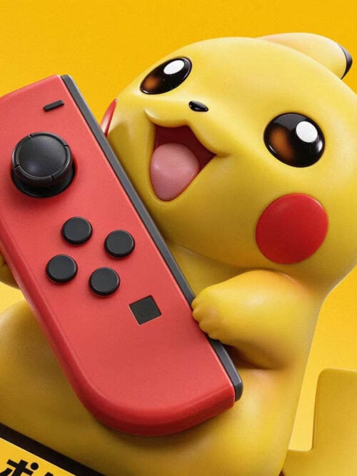 Close-up of yellow Pikachu's open smile and paws holding a red controller with black buttons.