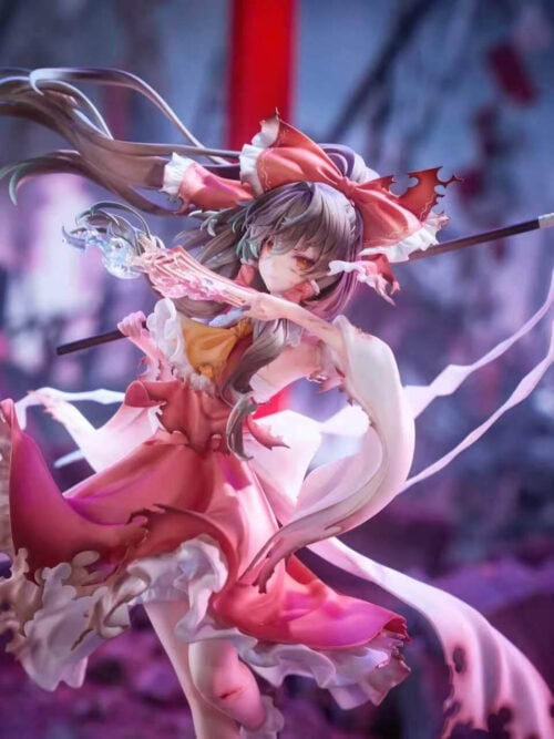 Three-quarter close-up of Reimu Hakurei holding a pink talisman near her face, with a dark wand, white paper streamers and torn sleeves.