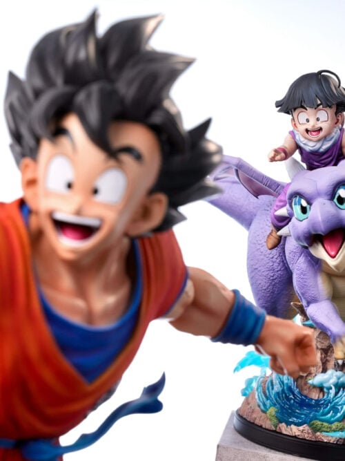 Son Gohan and Icarus statue in focus behind a separate, out-of-focus Son Goku statue against a white background.