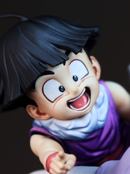 Close-up of Son Gohan's smiling face, black hair, pale blue scarf and textured purple outfit beside Icarus's horn.