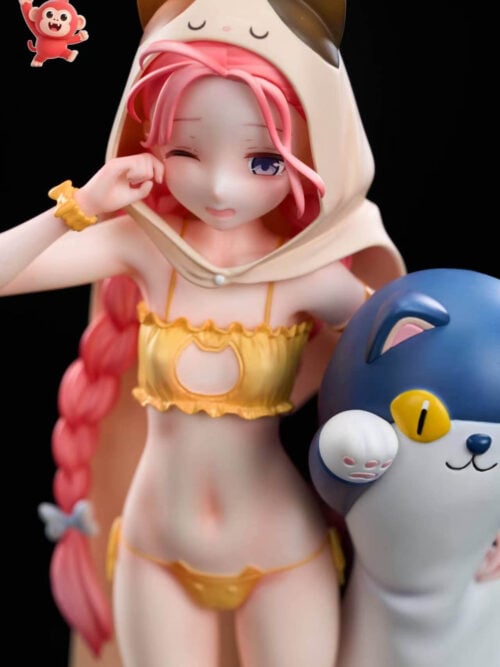 Close-up front view of the 1/7 scale Hanaoka Yuzu statue with the T-shirt removed, showing her yellow ruffled two-piece outfit with a cat-shaped front cutout under a cat-eared hooded cape next to a blue-and-white plush companion