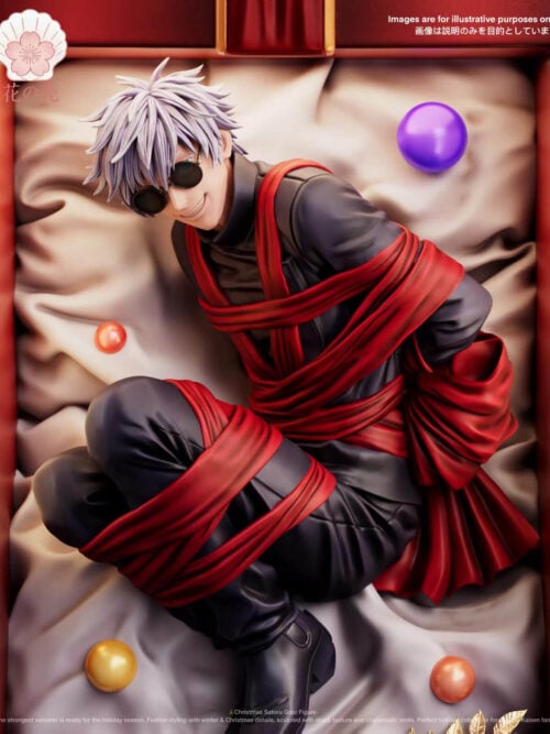 Closer front view of Satoru Gojo inside the red gift box, wearing round sunglasses and a dark outfit wrapped in red ribbon against sculpted white fabric and ornament balls.