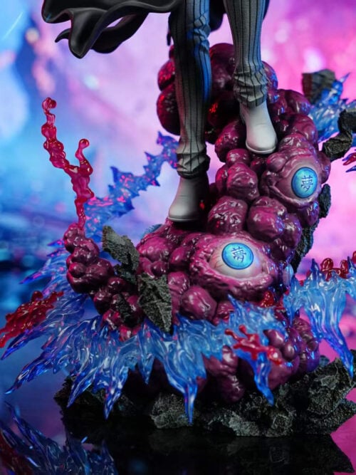 Close-up of the display base on DreamHunter Studio's 1/6 scale Enmu statue, showing his striped trousers and grey shoes atop purple demonic flesh studded with blue eyeballs inscribed with the Dream kanji, framed by dark rock and red and blue splashes.