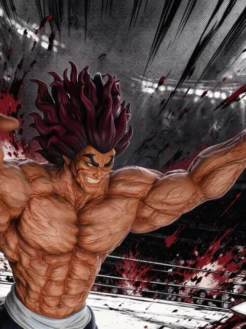 Close-up three-quarter view of the SuperPunch Studio Yujiro Hanma statue showing his wide grin, upward-swept dark red hair, and veined chest and arm musculature in front of an illustrated arena backdrop.
